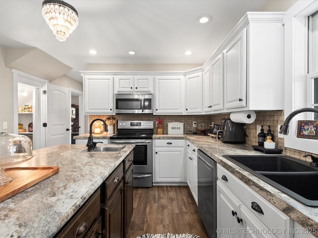 16145 Ew 255 Rd, Nowata, OK 74048 - kitchen with appliances with stainless steel finishes, white cabinetry, dark wood finished floors, tasteful backsplash, and dark brown cabinets