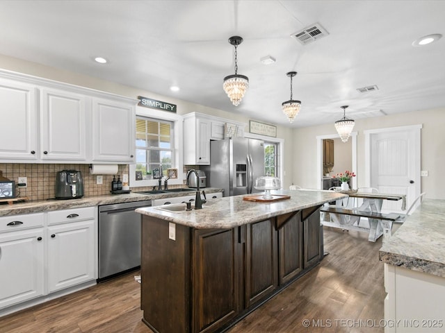 16145 Ew 255 Rd, Nowata, OK 74048 - kitchen featuring white cabinetry, an island with sink, plenty of natural light, appliances with stainless steel finishes, and recessed lighting