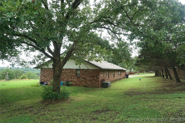 710 N 14th St, Henryetta, OK 74437 - view of side of property with a lawn and brick siding