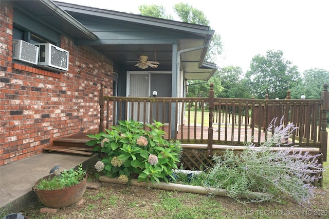 710 N 14th St, Henryetta, OK 74437 - property entrance with ceiling fan, a deck, and brick siding