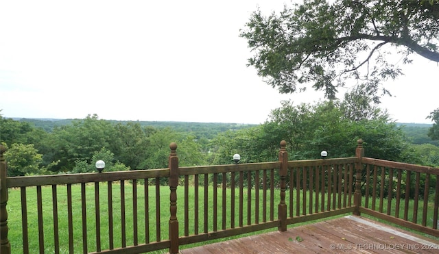 710 N 14th St, Henryetta, OK 74437 - wooden terrace featuring a yard and a view of trees