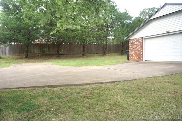 710 N 14th St, Henryetta, OK 74437 - view of yard featuring a garage and concrete driveway