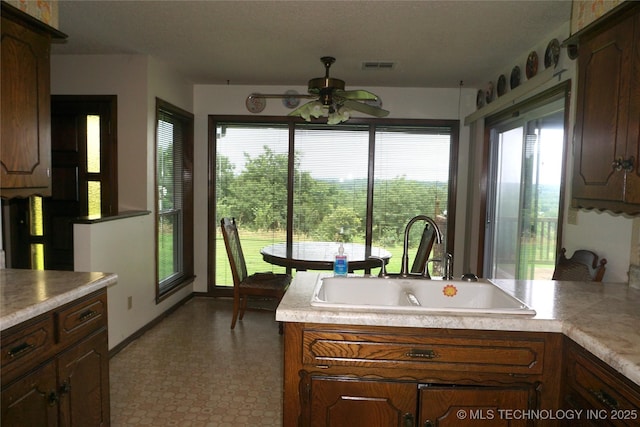 710 N 14th St, Henryetta, OK 74437 - kitchen with a ceiling fan, healthy amount of natural light, light countertops, and tile patterned floors