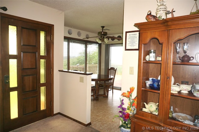 710 N 14th St, Henryetta, OK 74437 - entrance foyer with a ceiling fan and a textured ceiling
