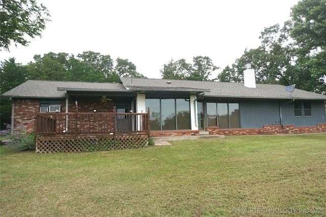 710 N 14th St, Henryetta, OK 74437 - rear view of house featuring a chimney, a yard, roof with shingles, and a sunroom