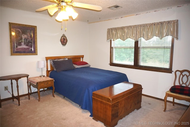 710 N 14th St, Henryetta, OK 74437 - bedroom with a textured ceiling, light carpet, and ceiling fan