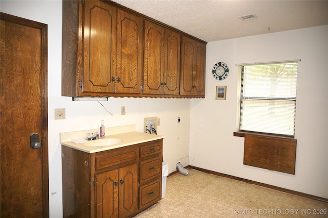 710 N 14th St, Henryetta, OK 74437 - laundry room featuring hookup for an electric dryer, hookup for a washing machine, cabinet space, and light floors