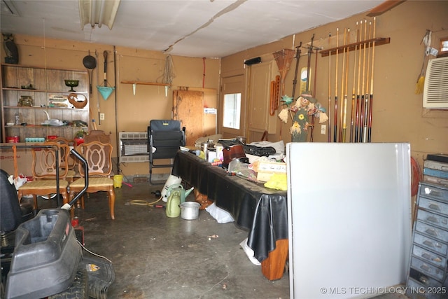 710 N 14th St, Henryetta, OK 74437 - miscellaneous room featuring concrete floors, heating unit, and a garage