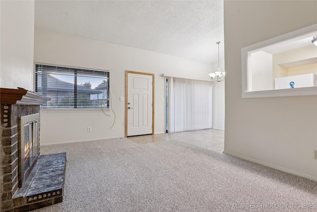 11030 E 11th Pl Unit 4A, Tulsa, OK 74128 - unfurnished living room with carpet flooring, a brick fireplace, a chandelier, and a textured ceiling