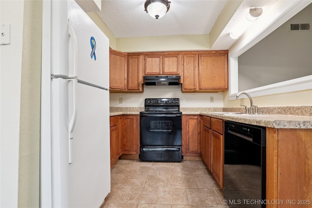11030 E 11th Pl Unit 4A, Tulsa, OK 74128 - kitchen with black appliances, under cabinet range hood, brown cabinets, and light countertops