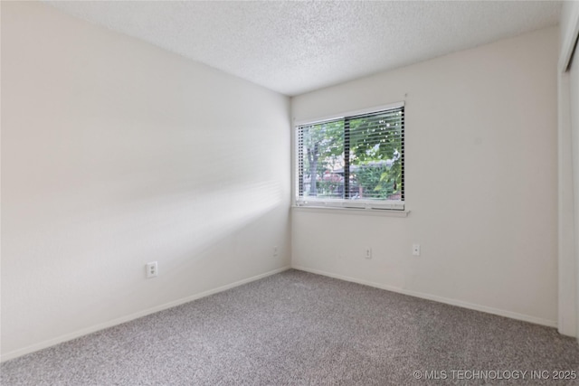 11030 E 11th Pl Unit 4A, Tulsa, OK 74128 - unfurnished room featuring carpet flooring and a textured ceiling