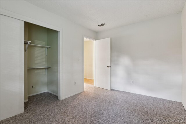 11030 E 11th Pl Unit 4A, Tulsa, OK 74128 - unfurnished bedroom featuring carpet flooring and a closet