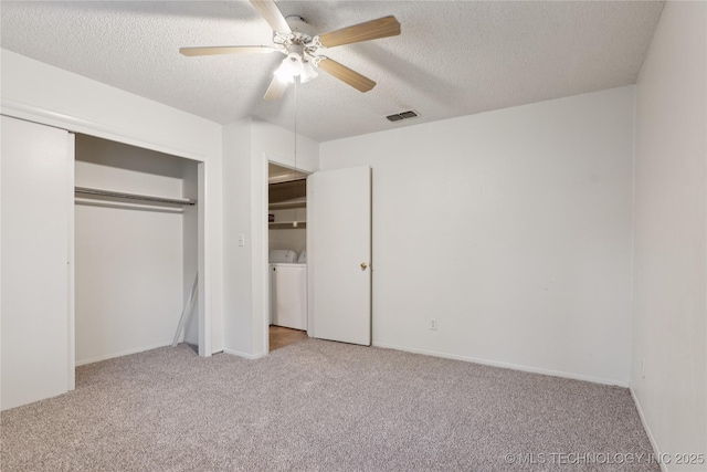 11030 E 11th Pl Unit 4A, Tulsa, OK 74128 - unfurnished bedroom with separate washer and dryer, carpet flooring, a textured ceiling, and a closet