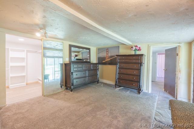 604 N N W, Konawa, OK 74849 - carpeted bedroom featuring a textured ceiling and baseboards