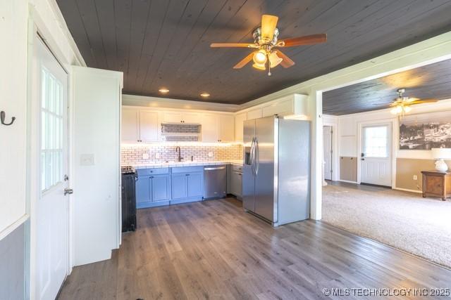 604 N N W, Konawa, OK 74849 - kitchen featuring stainless steel appliances, a ceiling fan, wood ceiling, light countertops, and wood finished floors