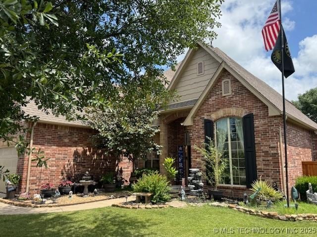 2511 E 138th St S, Bixby, OK 74008 - view of front of property featuring brick siding, a front lawn, and a garage