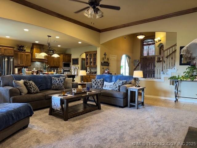 2511 E 138th St S, Bixby, OK 74008 - living room featuring ornamental molding, arched walkways, a ceiling fan, recessed lighting, and stairs