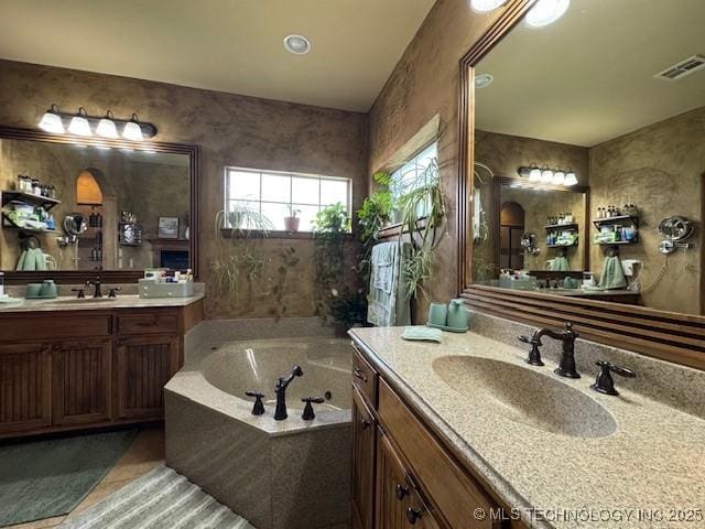 2511 E 138th St S, Bixby, OK 74008 - bathroom featuring two vanities, a bath, and tile patterned floors