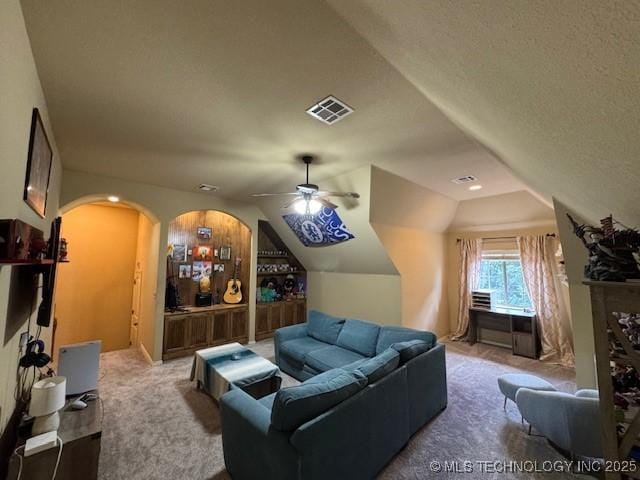 2511 E 138th St S, Bixby, OK 74008 - carpeted cinema featuring vaulted ceiling, arched walkways, and a ceiling fan