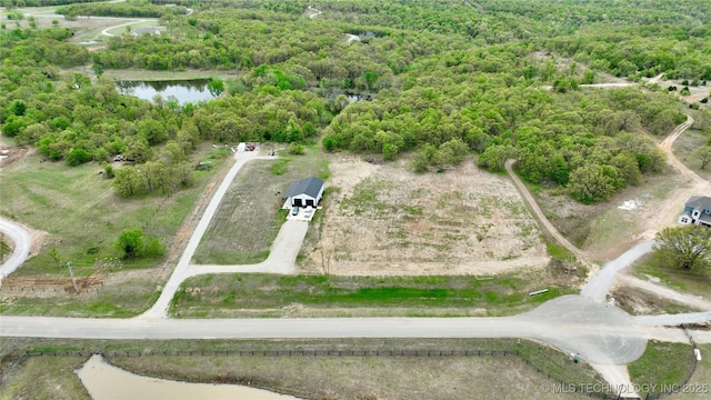 557 High Point Ln, Skiatook, OK 74070 - aerial overview of property's location with a nearby body of water and a heavily wooded area