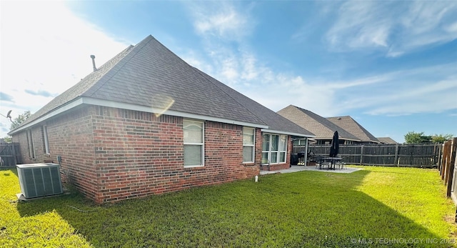 10219 N 119th E Ave, Owasso, OK 74055 - back of house with brick siding, a fenced backyard, a patio, and roof with shingles