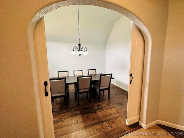 10219 N 119th E Ave, Owasso, OK 74055 - dining area featuring arched walkways, lofted ceiling, a chandelier, and dark wood finished floors