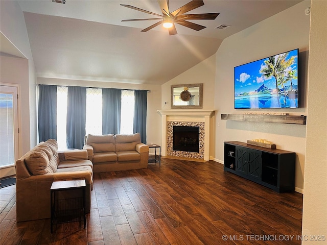10219 N 119th E Ave, Owasso, OK 74055 - living area with ceiling fan, a tiled fireplace, vaulted ceiling, and hardwood / wood-style floors