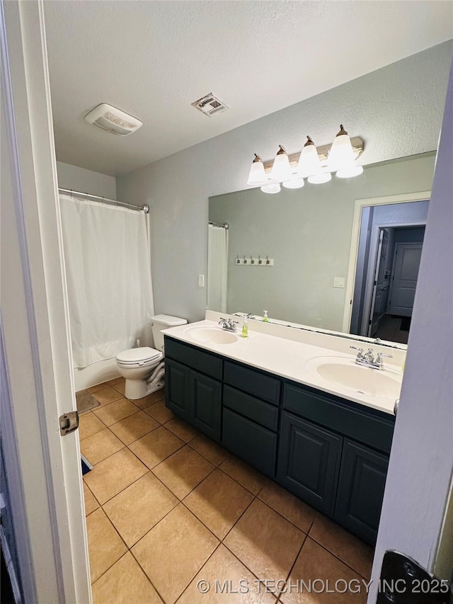 10219 N 119th E Ave, Owasso, OK 74055 - full bathroom with tile patterned floors, double vanity, a shower with shower curtain, and a textured ceiling