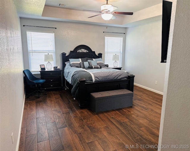 10219 N 119th E Ave, Owasso, OK 74055 - bedroom featuring dark wood-style flooring, a textured wall, a ceiling fan, and a tray ceiling