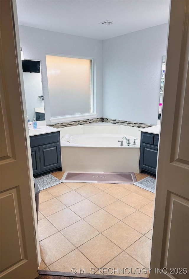 10219 N 119th E Ave, Owasso, OK 74055 - full bathroom with vanity, a garden tub, and tile patterned floors