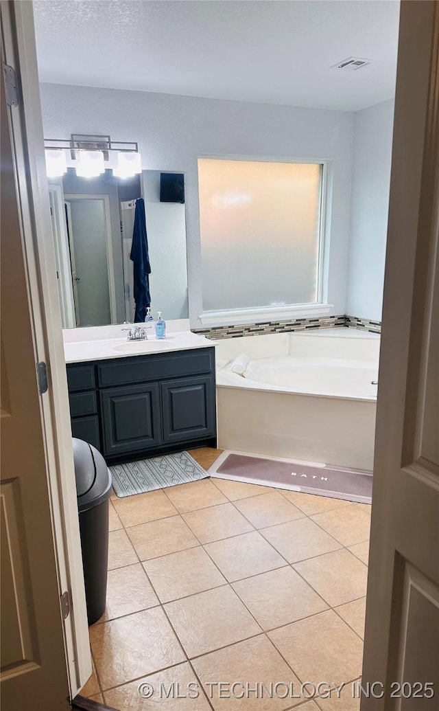 10219 N 119th E Ave, Owasso, OK 74055 - bathroom with a garden tub, vanity, and tile patterned flooring