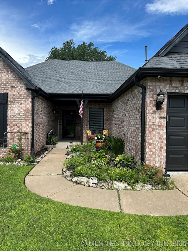 1821 W Lincoln St N, Broken Arrow, OK 74012 - doorway to property with brick siding, a shingled roof, an attached garage, and a lawn