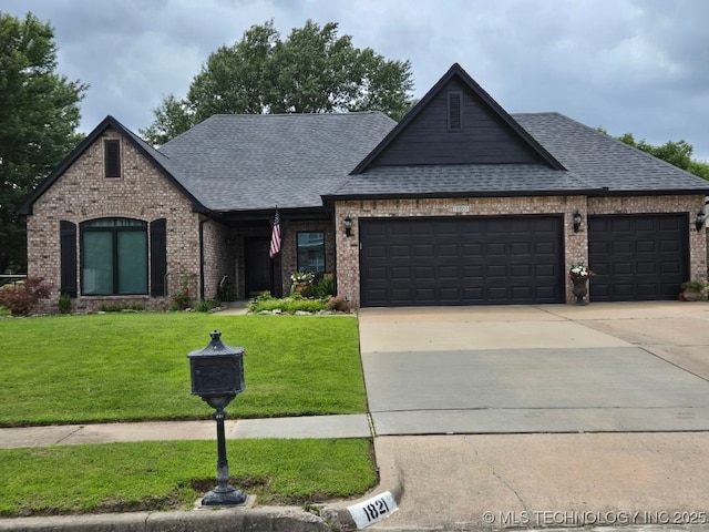 1821 W Lincoln St N, Broken Arrow, OK 74012 - view of front facade with a garage, brick siding, a shingled roof, and a front yard