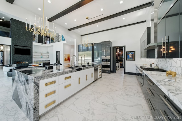 1226 W 109th Pl S, Jenks, OK 74037 - kitchen with a chandelier, modern cabinets, beam ceiling, light stone counters, and a large island with sink