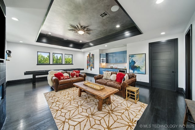 1226 W 109th Pl S, Jenks, OK 74037 - living room with a tray ceiling, wood finished floors, recessed lighting, and bar area
