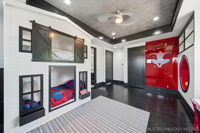 1226 W 109th Pl S, Jenks, OK 74037 - foyer featuring wood finished floors, a raised ceiling, a barn door, recessed lighting, and ceiling fan