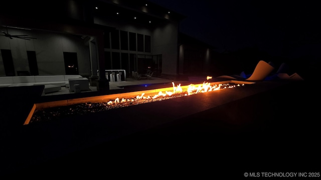 1226 W 109th Pl S, Jenks, OK 74037 - pool at night featuring an outdoor fire pit, a patio, and ceiling fan