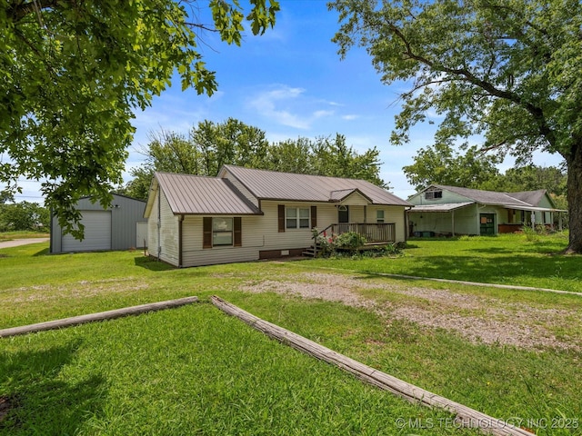 1322 Boundary Ave, Pawhuska, OK 74056 - ranch-style home with a metal roof, a front lawn, and an outdoor structure