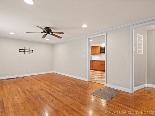 1322 Boundary Ave, Pawhuska, OK 74056 - empty room with ceiling fan, ornamental molding, light wood-style floors, and recessed lighting