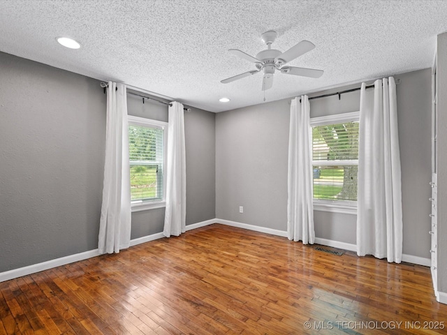 1322 Boundary Ave, Pawhuska, OK 74056 - empty room featuring a textured ceiling, hardwood / wood-style flooring, a ceiling fan, and recessed lighting