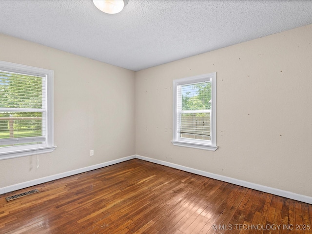 1322 Boundary Ave, Pawhuska, OK 74056 - unfurnished room featuring hardwood / wood-style flooring and a textured ceiling