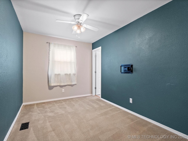 1322 Boundary Ave, Pawhuska, OK 74056 - carpeted spare room with a textured wall and ceiling fan