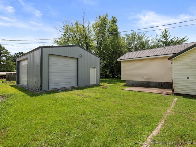 1322 Boundary Ave, Pawhuska, OK 74056 - view of green lawn featuring a detached garage and an outbuilding