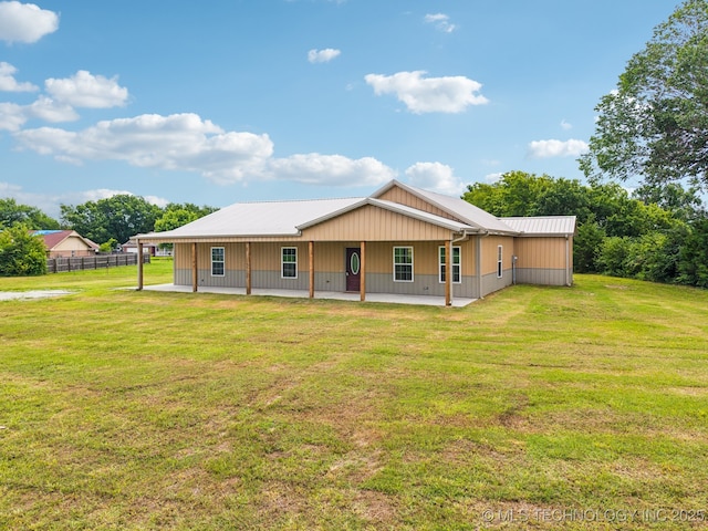 1102 W Main St, Beggs, OK 74421 - back of property with a patio area and a metal roof