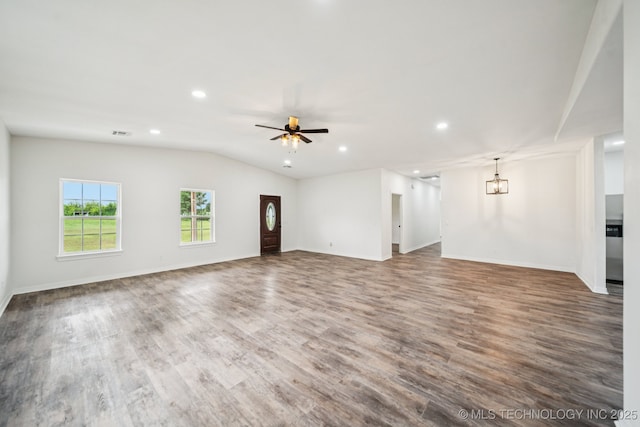 1102 W Main St, Beggs, OK 74421 - unfurnished living room featuring wood finished floors, a chandelier, recessed lighting, ceiling fan, and lofted ceiling