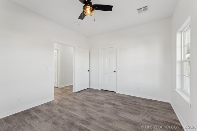 1102 W Main St, Beggs, OK 74421 - unfurnished bedroom with wood finished floors and a ceiling fan