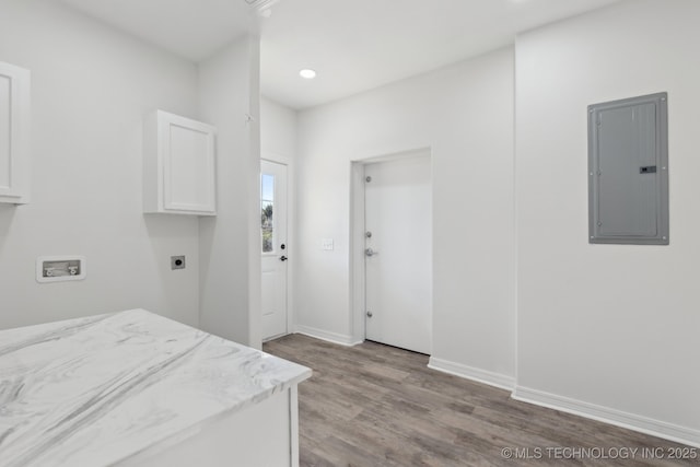 1102 W Main St, Beggs, OK 74421 - laundry room featuring electric panel, cabinet space, electric dryer hookup, wood finished floors, and hookup for a washing machine