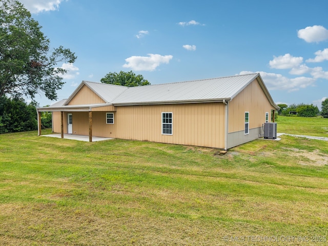 1102 W Main St, Beggs, OK 74421 - view of property exterior with a patio, a lawn, and a metal roof