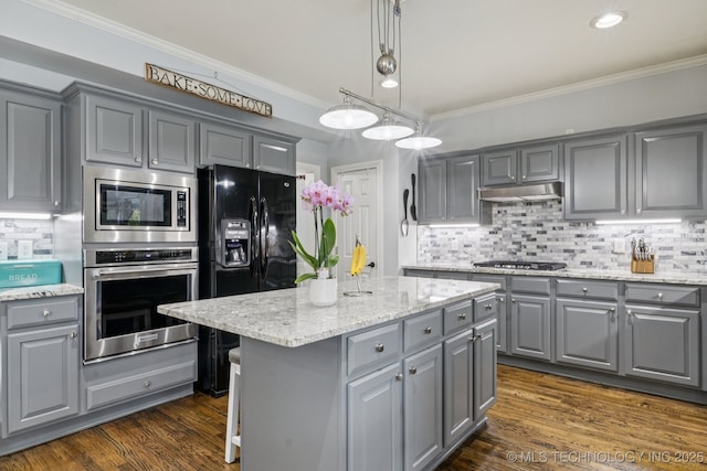 3701 W Dallas St, Broken Arrow, OK 74012 - kitchen featuring appliances with stainless steel finishes, gray cabinets, a kitchen island, crown molding, and tasteful backsplash