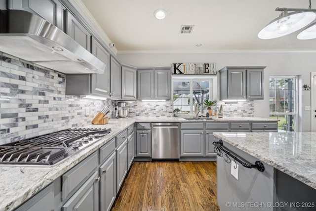 3701 W Dallas St, Broken Arrow, OK 74012 - kitchen featuring gray cabinets, wall chimney range hood, stainless steel appliances, ornamental molding, and decorative backsplash